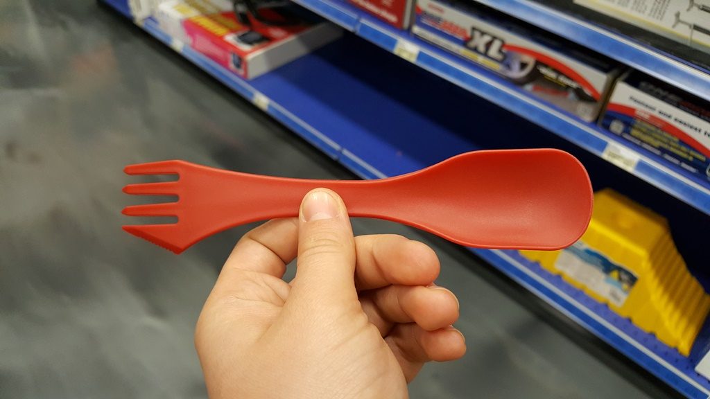 Holding one small item in a store aisle before deciding to buy